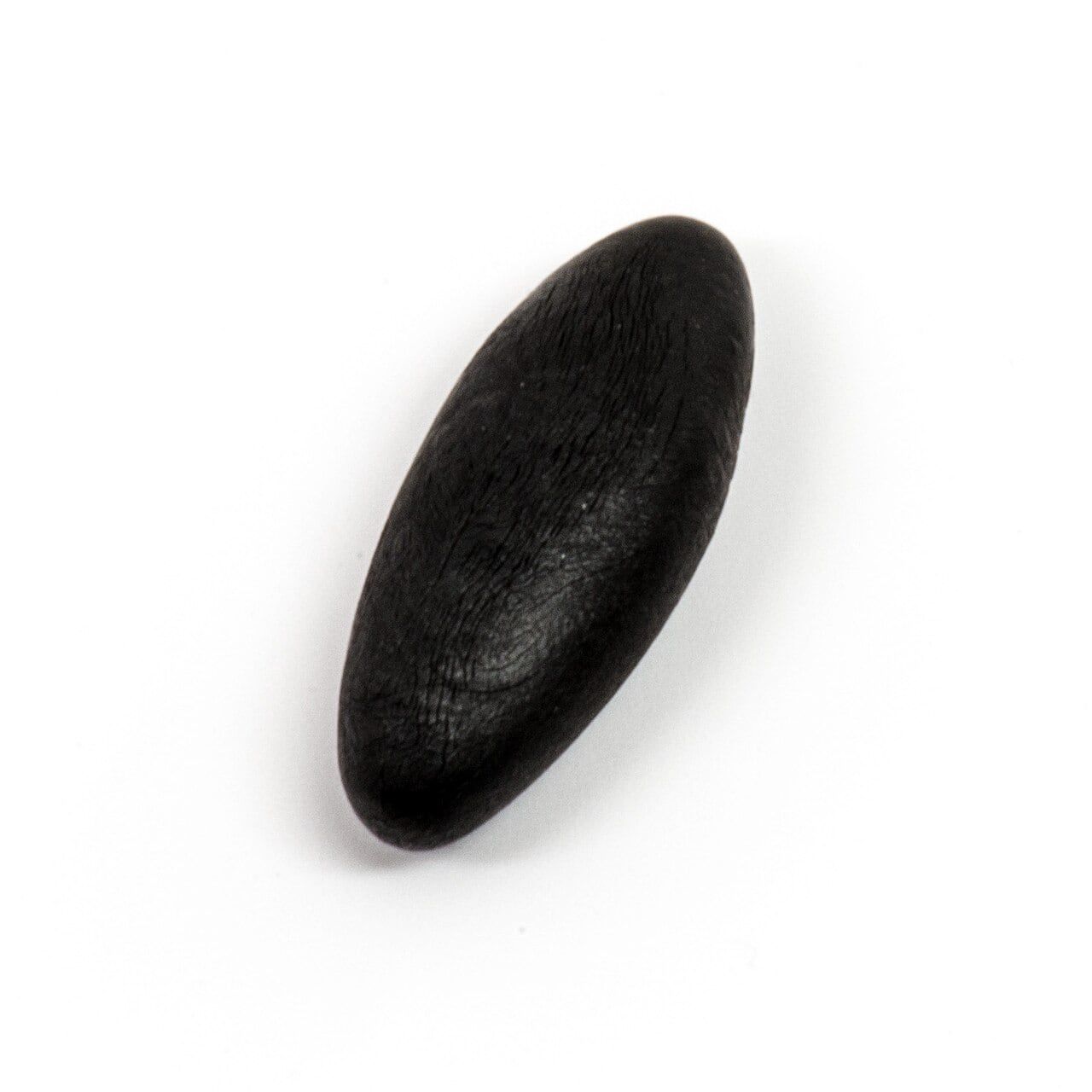 A smooth, glossy black piece of purified shilajit resin on a white background